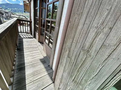 a wooden fence on a porch of a house at Duplex à Megève, 6 Couchages, Proche Centre et Pistes - FR-1-597-4 in Megève
