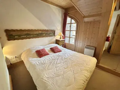 a bedroom with a bed with two red pillows on it at Duplex à Megève, 6 Couchages, Proche Centre et Pistes - FR-1-597-4 in Megève