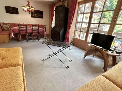 a living room with a couch and a table with a television at Duplex à Megève, 6 Couchages, Proche Centre et Pistes - FR-1-597-4 in Megève