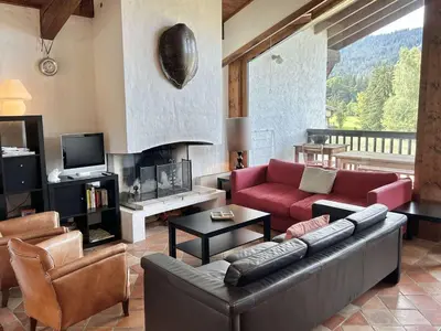 a living room with a red couch and chairs at Duplex 4 pièces, 8 couchages, jardin, parking, près des pistes - FR-1-597-3 in Megève