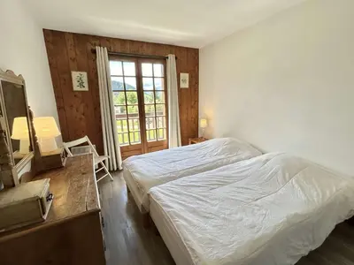 a bedroom with a bed and a large window at Duplex 4 pièces, 8 couchages, jardin, parking, près des pistes - FR-1-597-3 in Megève