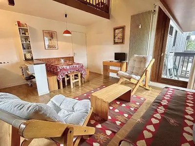 a living room with a couch and a table at Appart 2 pièces + mezzanine, 6 couchages, Megève, parking - FR-1-597-7 in Megève