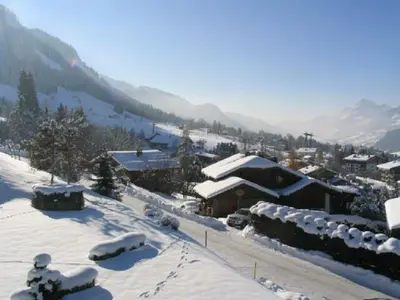 a village covered in snow with mountains in the background at Appart 2 pièces + mezzanine, 6 couchages, Megève, parking - FR-1-597-7 in Megève