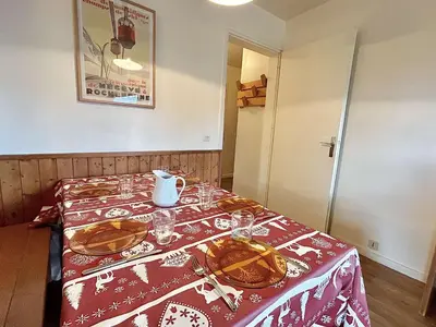 a table with plates and glasses on a red table cloth at Appart 2 pièces + mezzanine, 6 couchages, Megève, parking - FR-1-597-7 in Megève