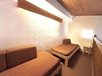 a room with two beds and a couch and a table at Appart 2 pièces + mezzanine, 6 couchages, Megève, parking - FR-1-597-7 in Megève