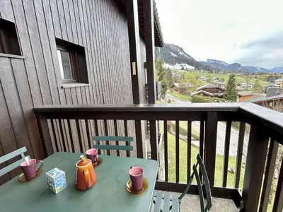 a table with cups on a balcony with a view at Appart 2 pièces + mezzanine, 6 couchages, Megève, parking - FR-1-597-7 in Megève