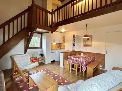 a living room with a table and a kitchen at Appart 2 pièces + mezzanine, 6 couchages, Megève, parking - FR-1-597-7 in Megève