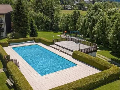 an overhead view of a swimming pool in a yard at Studio avec Piscine Chauffée, Tennis & Balcon - 4 Couchages à Megève - FR-1-597-14 in Megève