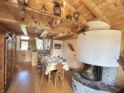 a dining room with a table and a stone fireplace at Appartement Duplex 2 pièces, 4 couchages, proche pistes de ski, garage, Demi-Quartier - FR-1-597-16 in Demi-Quartier
