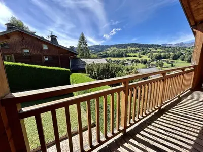 a wooden balcony with a view of a house at Appartement Duplex 2 pièces, 4 couchages, proche pistes de ski, garage, Demi-Quartier - FR-1-597-16 in Demi-Quartier