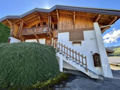 a large house with a porch and a balcony at Appartement Duplex 2 pièces, 4 couchages, proche pistes de ski, garage, Demi-Quartier - FR-1-597-16 in Demi-Quartier