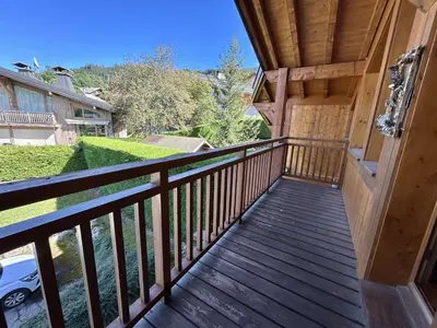 a balcony of a house with a wooden railing at Appartement Duplex 2 pièces, 4 couchages, proche pistes de ski, garage, Demi-Quartier - FR-1-597-16 in Demi-Quartier