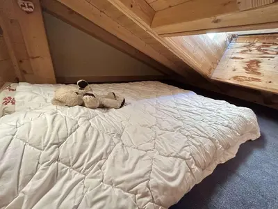 two stuffed animals sitting on top of a bed at Appartement Duplex 2 pièces, 4 couchages, proche pistes de ski, garage, Demi-Quartier - FR-1-597-16 in Demi-Quartier