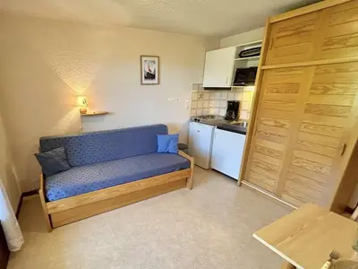a small room with a blue couch in a kitchen at Studio confortable avec balcon, proche des pistes - 2 couchages à Demi-Quartier - FR-1-597-18 in Demi-Quartier
