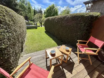 a patio with chairs and a table on a deck at Studio Alcôve Cosy, 4 Pers, Jardin, Parking, Proche Télécabine et Golf - Megève - FR-1-597-21 in Megève