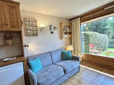 a living room with a blue couch and a window at Studio Alcôve Cosy, 4 Pers, Jardin, Parking, Proche Télécabine et Golf - Megève - FR-1-597-21 in Megève