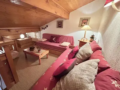 a living room with a couch and a table at Appartement cosy à Megève: 3 pièces + mezzanine, 4 couchages - Proche remontées mécaniques et golf - FR-1-597-19 in Megève