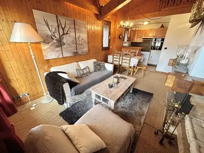 a living room with a couch and a table at Appartement cosy à Megève: 3 pièces + mezzanine, 4 couchages - Proche remontées mécaniques et golf - FR-1-597-19 in Megève