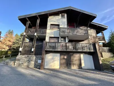 a house with a garage and a balcony at Appartement cosy à Megève: 3 pièces + mezzanine, 4 couchages - Proche remontées mécaniques et golf - FR-1-597-19 in Megève