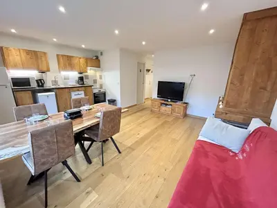 a living room with a dining table and a kitchen at Studios + Cabine à Megève, 4 Couchages, 500m des Remontées, Balcon Sud, Parking Inclus - FR-1-597-34 in Megève