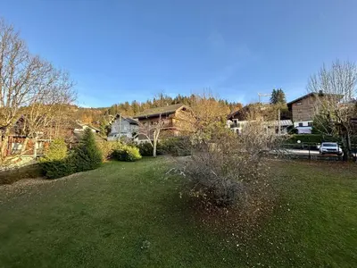 a yard with a house in the background at Studios + Cabine à Megève, 4 Couchages, 500m des Remontées, Balcon Sud, Parking Inclus - FR-1-597-34 in Megève