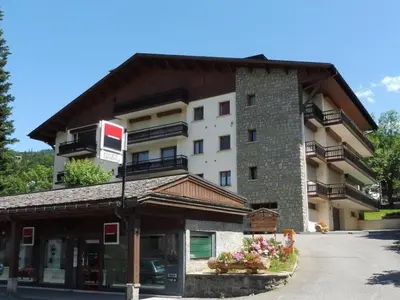 a large building with a sign on top of it at Studios + Cabine à Megève, 4 Couchages, 500m des Remontées, Balcon Sud, Parking Inclus - FR-1-597-34 in Megève