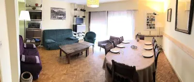 a living room with a table and a couch at Résidence Paradiso - Paradiso B2 MAE-5224 in Saint-Gervais-les-Bains
