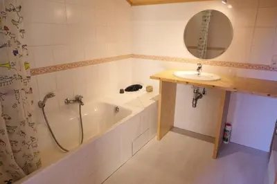 a bathroom with a bath tub and a sink at Chalet Granier - Chalet Granier MAE-5234 in Saint-Gervais-les-Bains
