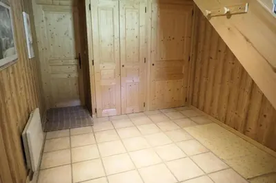 an attic room with wooden walls and tiled floors at Chalet Granier - Chalet Granier MAE-5234 in Saint-Gervais-les-Bains