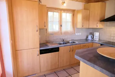 a kitchen with wooden cabinets and a sink at Chalet Granier - Chalet Granier MAE-5234 in Saint-Gervais-les-Bains