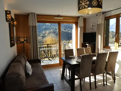 a living room with a couch and a table with chairs at Résidence Les Fermes De Saint Gervais - Fermes de Saint Gervais A4 MAE-5238 in Saint-Gervais-les-Bains