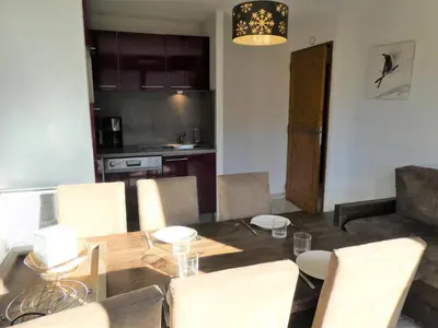 a dining room with a table and chairs and a kitchen at Résidence Les Fermes De Saint Gervais - Fermes de Saint Gervais A4 MAE-5238 in Saint-Gervais-les-Bains