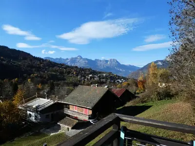 a house on a hill with mountains in the background at Résidence Les Fermes De Saint Gervais - Fermes de Saint Gervais A4 MAE-5238 in Saint-Gervais-les-Bains