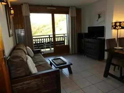 a living room with a couch and a television at Résidence Les Fermes De Saint Gervais - Fermes de Saint Gervais A7 MAE-5287 in Saint-Gervais-les-Bains