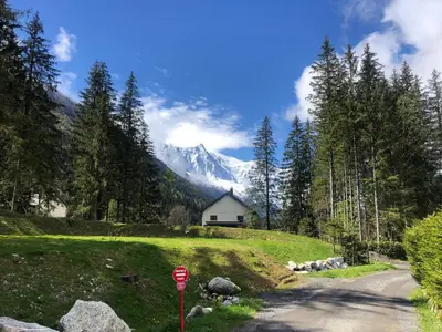 a stop sign in front of a house on a mountain at Chalet Orval - Chamonix Argentière in Chamonix-Mont-Blanc