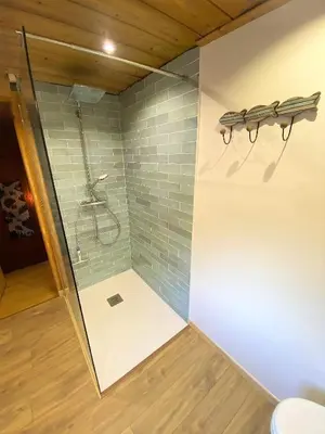 a shower with a glass door in a bathroom at Chalet Orval - Chamonix Argentière in Chamonix-Mont-Blanc