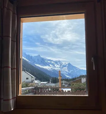 a window with a view of a snow covered mountain at Chalet Orval - Chamonix Argentière in Chamonix-Mont-Blanc