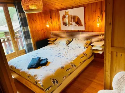 a bedroom with a bed in a wooden room at Chalet Orval - Chamonix Argentière in Chamonix-Mont-Blanc