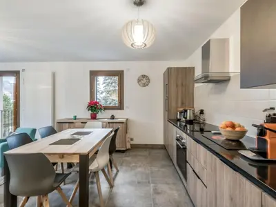 a kitchen with a table and chairs in a room at DIFY Appartement Luxe - Saint Gervais in Saint-Gervais-les-Bains