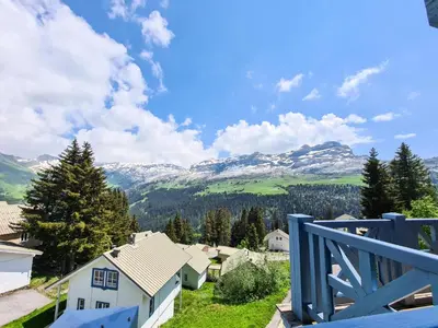a view of the mountains from the balcony of a house at Résidence Hameau - Chalet lumineux · Poêle à bois · Sauna · Garage MAE-7348 in Flaine