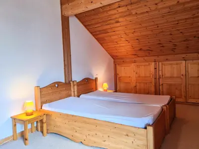 a wooden bed in a room with a wooden ceiling at Résidence Hameau - Chalet lumineux · Poêle à bois · Sauna · Garage MAE-7348 in Flaine