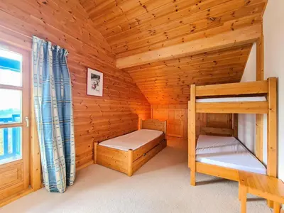 a wooden room with bunk beds and a window at Résidence Hameau - Chalet lumineux · Poêle à bois · Sauna · Garage MAE-7348 in Flaine