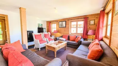 a living room with a couch and a table at Résidence Hameau - Chalet spacieux · Sauna · Cheminée MAE-7349 in Flaine