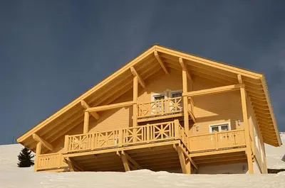 a wooden building with a balcony in the snow at Résidence Hameau - Chalet spacieux · Sauna · Cheminée MAE-7349 in Flaine