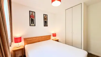 a bedroom with a white bed and two lamps at Résidence Les Pleiades - Appartement lumineux et confortable · Centre station · Balcon · Parking couvert MAE-7351 in Flaine
