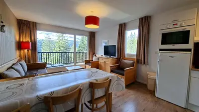 a living room with a table and a large window at Résidence Les Pleiades - Appartement spacieux avec balcon · Centre station · Parking couvert MAE-7352 in Flaine