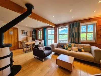 a living room with a couch and a table at Résidence Hameau - Chalet lumineux · Poêle à bois · WIFI gratuit et illimité · Garage MAE-7353 in Flaine