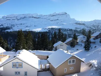 a group of houses in the snow with a mountain at Résidence Hameau - Chalet lumineux · Poêle à bois · WIFI gratuit et illimité · Garage MAE-7353 in Flaine