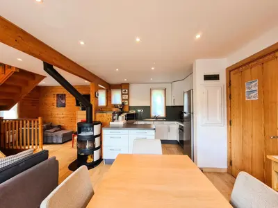 a kitchen with a wooden table and a stove at Résidence Hameau - Chalet lumineux · Poêle à bois · WIFI gratuit et illimité · Garage MAE-7353 in Flaine