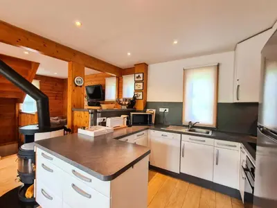 a large kitchen with white cabinets and a stove at Résidence Hameau - Chalet lumineux · Poêle à bois · WIFI gratuit et illimité · Garage MAE-7353 in Flaine